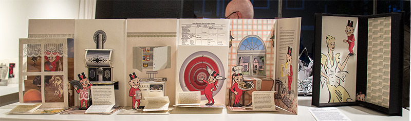 a long pop-up book depicting a stereotypical 1950s kitchen