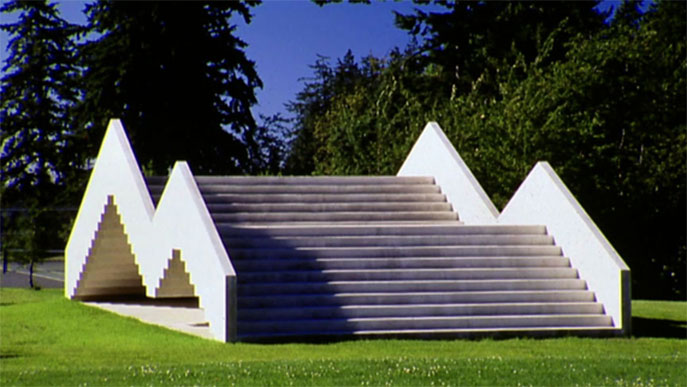 monumental sculpture in the form of two broad staircases of concrete on a green lawn