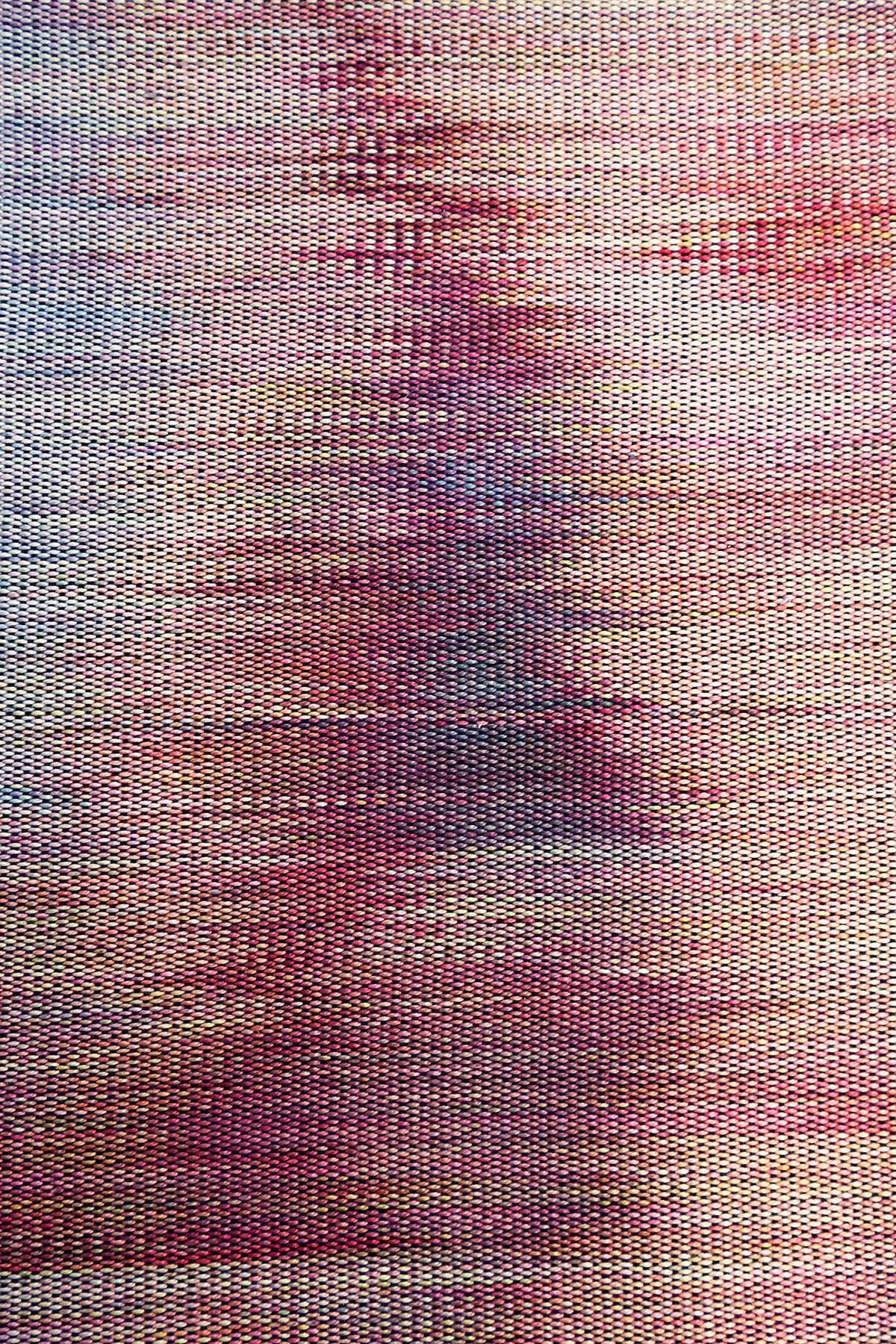 detail of a woven textile with strong horizontal lines shows a hazy image of the crook of an elbow and a bare breast