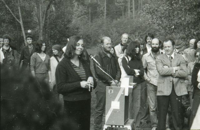 a group of people at a sculpture dedication