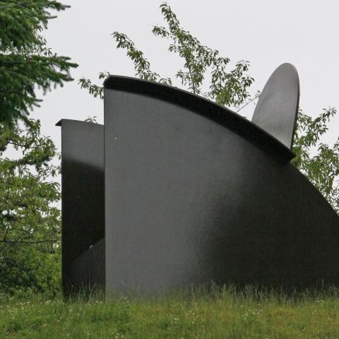 Side view of David Ireland's sculpture Bigger Big Chair. Full description in body text.