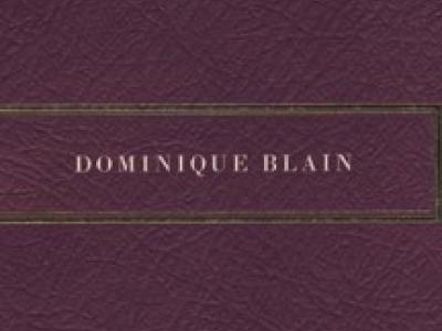 burgundy field with small letters reading "Dominique Blain"