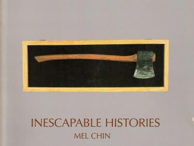 A framed axe above the title of the exhibition: "Mel Chin: Inescapable Histories"