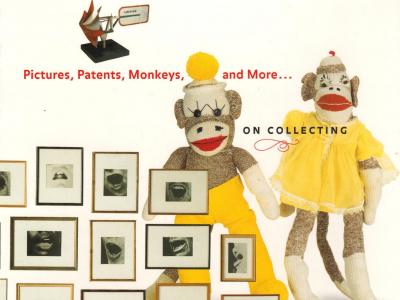an arrangement of framed photos and two sock monkeys dressed in yellow