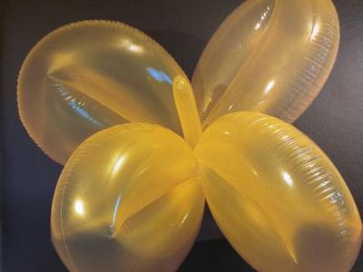 a yellow clover shaped balloon object
