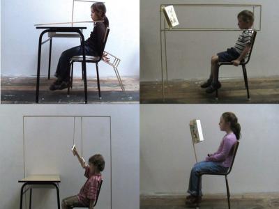 Four images in a grid: each shows a child in a school chair in an otherwise empty space. Two images show a book attached to the chair and held up at reading level in front of the child. The other two images show a school desk in front of the child.