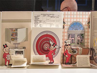 a long pop-up book depicting a stereotypical 1950s kitchen