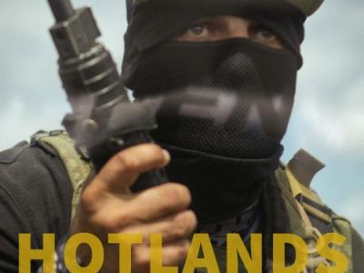person in army fatigues with face covered holding an assault weapon - text over image says "Hot Lands"