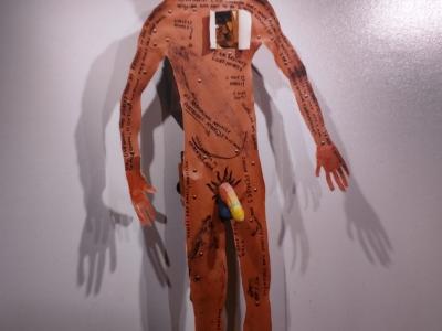 stiff human form made of cardboard and other things