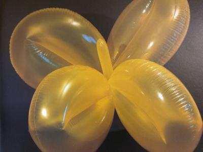 a yellow clover shaped balloon object