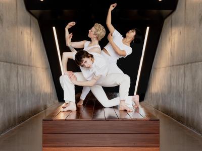 Three dancers in an angular, sculptural pose