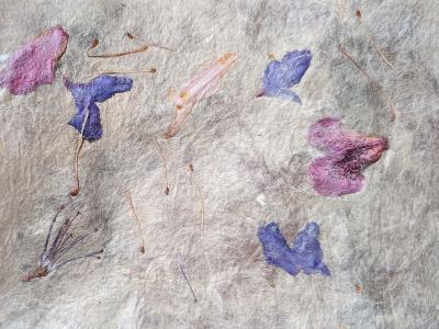heavily textured hand crafted paper with floral motif in blue and purple